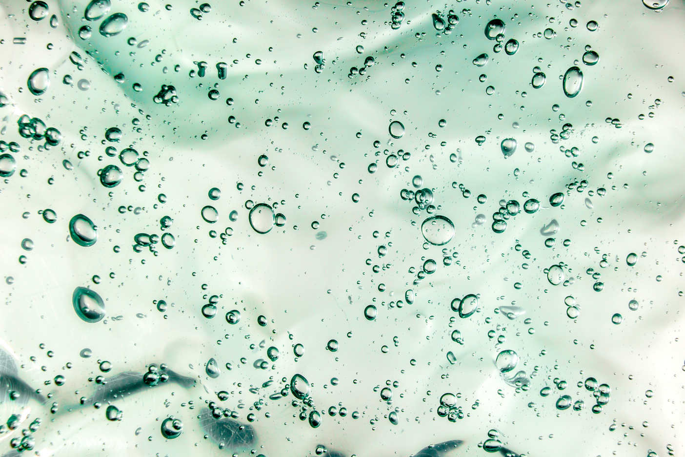 Liquid cream gel, green blue cosmetic texture with bubbles